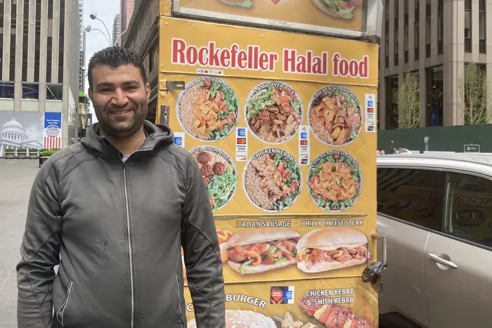 Sherif Baioumy poses by his halal truck in Midtown.